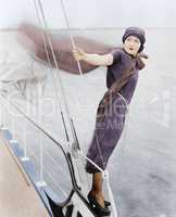 Woman leaning off boat into the wind