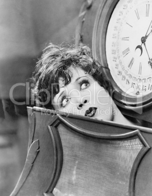 Closeup of woman inside clock