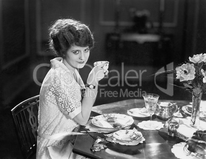Portrait of woman eating meal at table