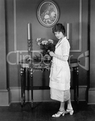 Woman decorating with bouquet of flowers