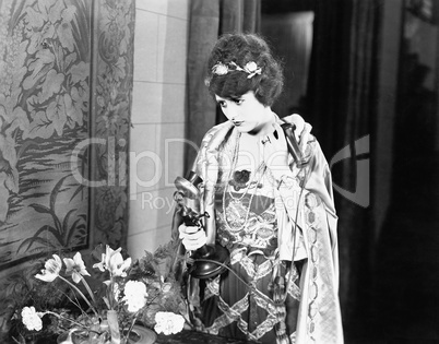 Portrait of woman using telephone