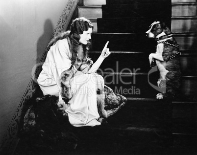 Woman scolding dog on stairs