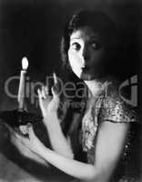 Portrait of fearful woman with candle