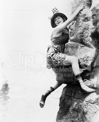 Portrait of woman climbing rock cliff