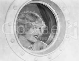 Woman looking through porthole