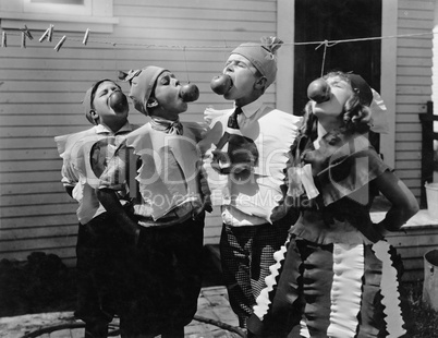 Kids biting apples on strings at Halloween