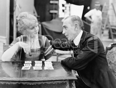 Man with woman playing card game