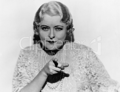 Portrait of mature woman pointing finger