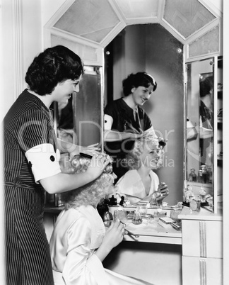 Woman combing another womans hair