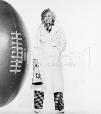 Portrait of woman with huge football