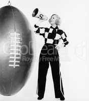 Woman with megaphone and huge football
