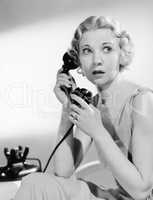Shocked woman on telephone