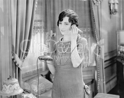 Portrait of woman talking on telephone