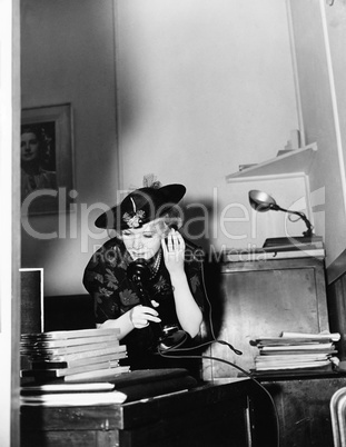 Woman talking on phone in office