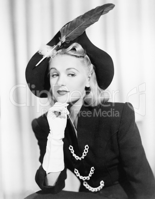 Portrait of woman wearing hat with feather