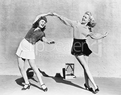 Two women dancing outside