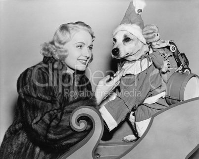 Woman with dog in Christmas outfit