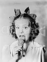 Girl licking ice cream cone