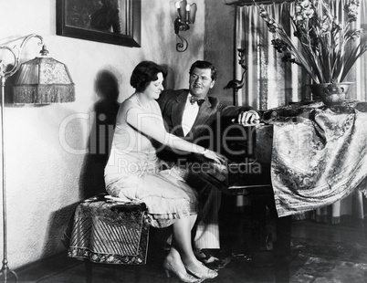 Couple sitting at piano