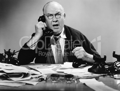 Businessman using multiple phones