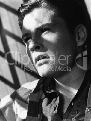 Portrait of young man with shadow of bars