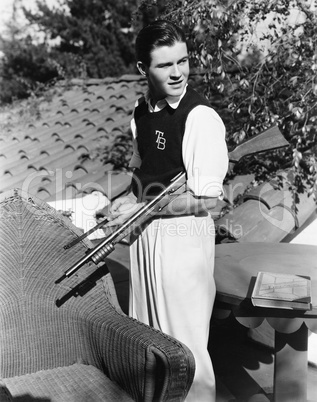 Portrait of young man outside with gun