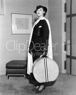 Portrait of woman carrying hatbox