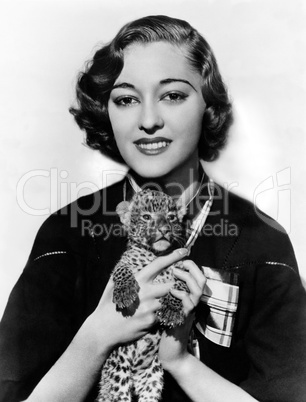 Woman holding tiny leopard cub