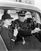 Woman using radio in car with policeman