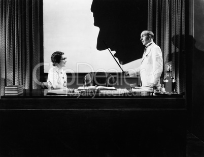 Man and woman with silhouette of huge nose