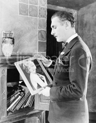 Man looking at picture of woman