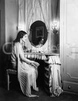Woman sitting at dressing table