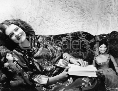 Woman on couch with dolls