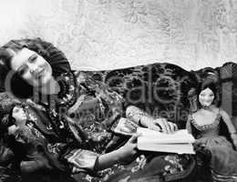 Woman on couch with dolls