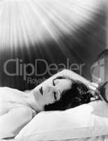 Sleeping woman with beams of light