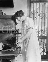 Woman cooking on stove