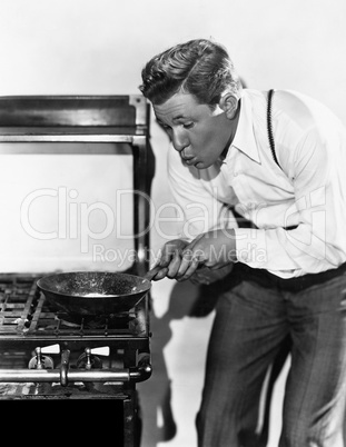 Portrait of man cooking on stove