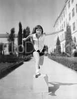 Girl leaping over wooden blocks