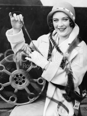 Young woman smiling with film wrapped around her