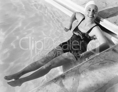 Young woman relaxing in a pool