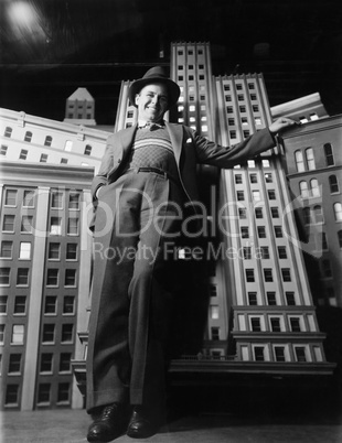 Man leaning against model buildings