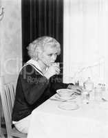 Young woman having breakfast in a restaurant