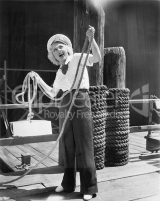 Ahoy, from a young woman in a sailor's outfit, holding a heavy rope