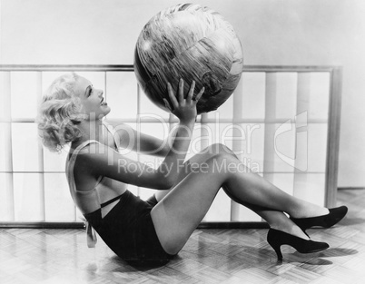 Young woman exercising with a big ball