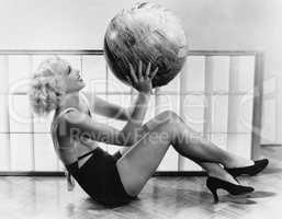 Young woman exercising with a big ball