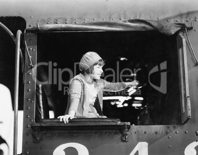 Little girl in a beret driving a train