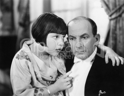 Father and daughter talking to each other in a living room