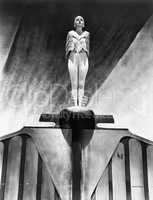 Young woman standing like a statue