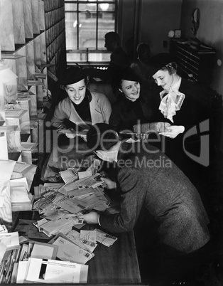 Group of people going through a pile of mail