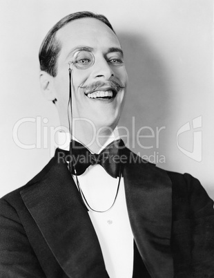 Man laughing and a monocle